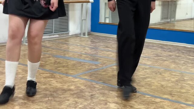 Close-up of female and male legs dancing traditional Irish stepdance. 