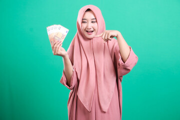 Young muslim woman presents money, financial security and succes