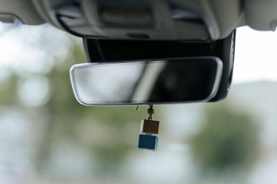Car Rearview Mirror With Hanging Air Freshener In Focus