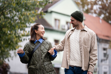 Happy interracial couple enjoying an autumn walk together © Zoran Jesic