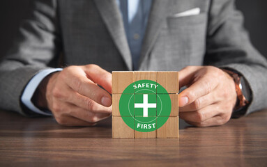 Safety first symbols, work safety, caution work hazards, danger surveillance, zero accident concept. Wooden cubes with smart grey background. Employees safety awareness at workplace. Safety banner.