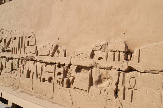 Ancient Egyptian hieroglyphs on stone wall, Karnak Temple Complex, Luxor, Egypt, Africa. Stone carvings with hieroglyphs at Karnak temple, Luxor, Thebe
