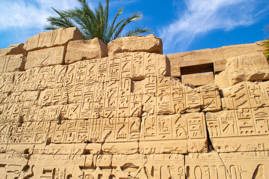 Ancient Egyptian hieroglyphs on stone wall, Karnak Temple Complex, Luxor, Egypt, Africa. Stone carvings with hieroglyphs at Karnak temple, Luxor, Thebe - Powered by Adobe