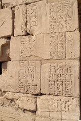 Ancient Egyptian hieroglyphs on stone wall, Karnak Temple Complex, Luxor, Egypt, Africa. Stone carvings with hieroglyphs at Karnak temple, Luxor, Thebe