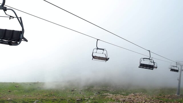 Climb up the mountain, ride the cable car inside the clouds, Rosa Khutor mountain resort. a trip by cable car. shooting from the booth