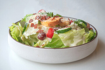 Caesar Salad: Crisp romaine lettuce tossed with Parmesan, croutons, and a creamy Caesar dressing,