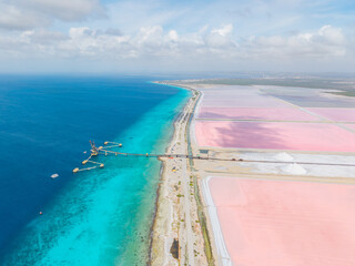 Aerial view of pink salt ponds and white salt pyramids in Bonaire