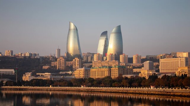 Baku Azerbaijan waterfront skyline timelapse featuring towers resembling flame. Cityscape with modern and classic architecture in the sunny morning at sunrise hyper lapse.