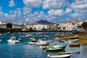 Arrecife Lanzarote showcasing colorful boats in the harbor set against a backdrop of historic...