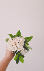a small bouquet of jasmine in the bride's hand