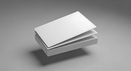 Clean, crisp stack of blank white business cards effortlessly floats above a minimalist base, ready for custom branding or elegant presentation