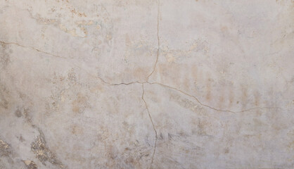 An aged wall with cracks in beige tones. Space for creative advertising text. Copy space 