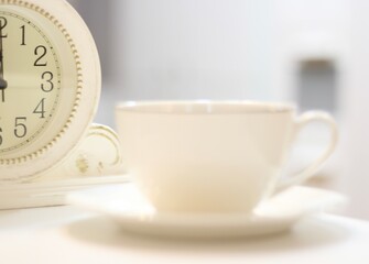 Clock and white cup and saucer interior detail photo 