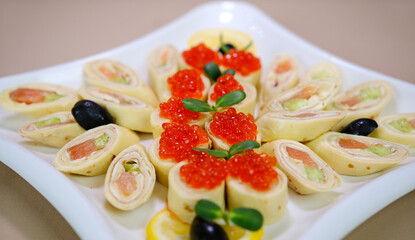 thin pancakes Salmon rolls caviar traditional treat. Stack of russian thin pancakes blini with red caviar. . High quality photo