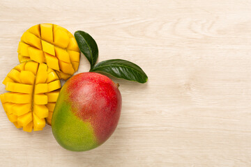 Fresh ripe mango on wooden background, top view