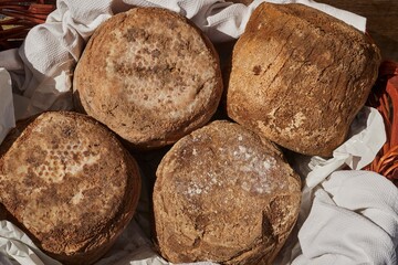 Whole cheeses at a market in Entracque, Cuneo, Piedmont, Italy
