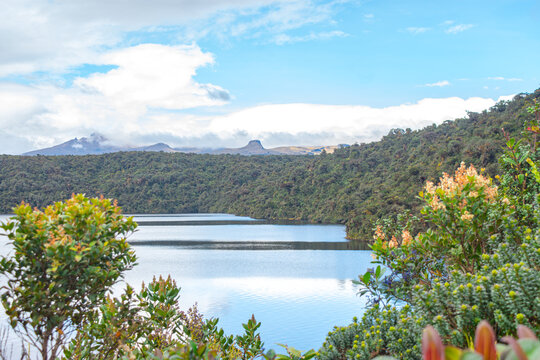Scenic view of the Buey Lagoon surrounded by lush greenery and mountains in Purace, Cauca, Colombia.