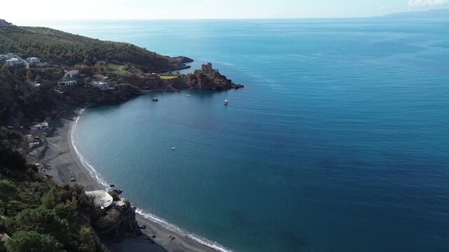 Aerial cinematic view of a Saracen tower surrounded by the blue sea in Calabria southern Italy historical landmark linked to American writer Crawford 2