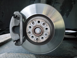 Brake disc and brake pads. Car at service station. Wheel disassembly and repair