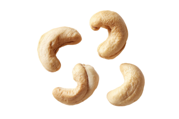 Four whole cashews arranged in a symmetrical, starburst pattern on a black background
