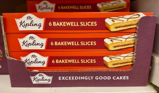 Camberley, UK - October 11, 2025: Boxes of Mr Kipling Bakewell Slices stacked in a branded cardboard tray on sale in a British supermarket. 