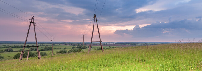 Field of grass with two tall poles in the background