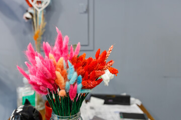 Vase of flowers with pink, blue, and red flowers