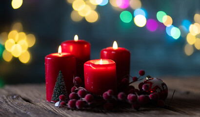 candles burning against holiday lights background