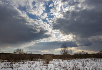 Field of snow with a cloudy sky in the background