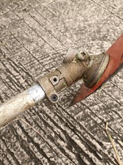 close up photo of the lawn mower blade part of an old lawn mower that still uses fuel oil