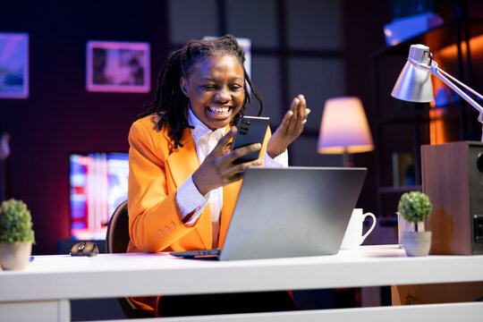 Euphoric woman watching funny videos on social media using mobile phone. Cheerful girl using social network website on smartphone, amused by hysterical content, enjoying time off at home - Powered by Adobe