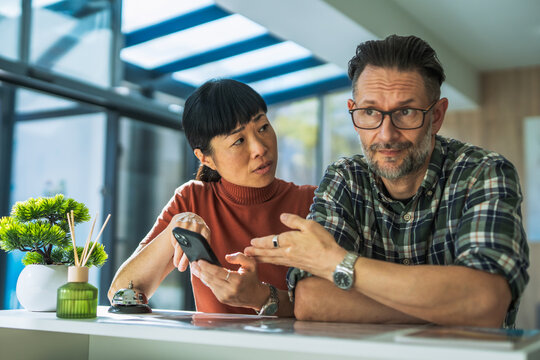 Couple complaining about hotel service at reception desk