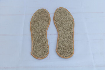 Pair of warm wool shoe insoles on white background