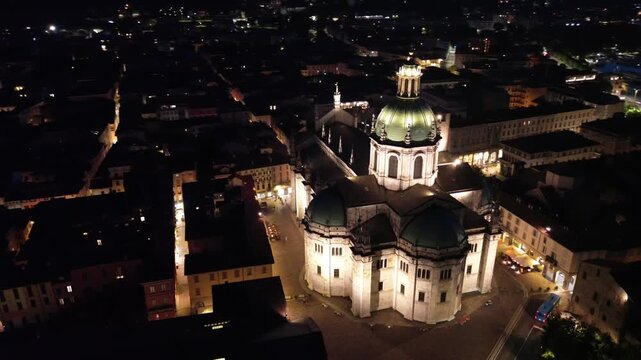 nocturnal aerial view of Como Cathedral illuminated with cinematic lights showcasing the intricate details of the dome from above 7