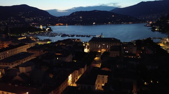 nocturnal aerial view of Como Cathedral illuminated with cinematic lights showcasing the intricate details of the dome from above 4