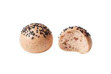 Two round buns, one whole and one halved, are displayed against a black background.  The buns are light beige with black sesame seeds sprinkled over the surface.  