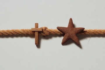 minimalist composition featuring rope star and cross on clean background emphasizing abstract minimalism