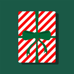 A red and white striped gift box with a green bow on top