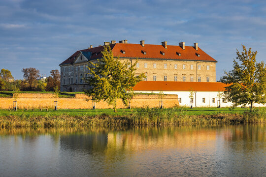 Holic, Slovakia - October 12, 2024: The Holic castle. Scenic view of an old building reflected in the tranquil water, set against a clear sky and lush trees. Peaceful landscape scene.
