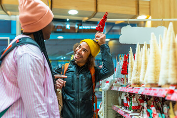 Happy diverse couple enjoying christmas holiday shopping