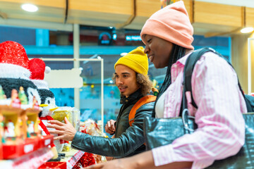 Diverse couple enjoying christmas season shopping in store