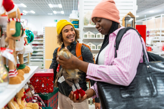 Diverse couple enjoying christmas shopping for holiday decorations