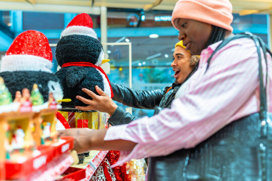 Diverse couple enjoying christmas shopping for holiday decorations