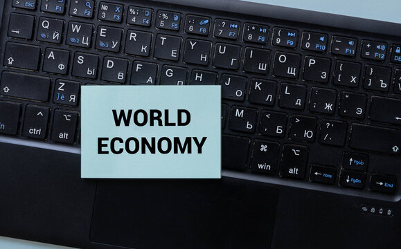 ECONOMIC SUMMIT text on card held by hands, concept for global meetings