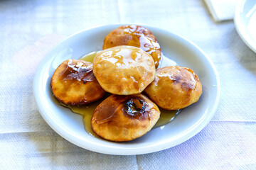 Mizithropitakia, a home made honey garnished cheese pie, a Cretan local traditional sweet delicacy with cottage cheese, Crete, Greece.