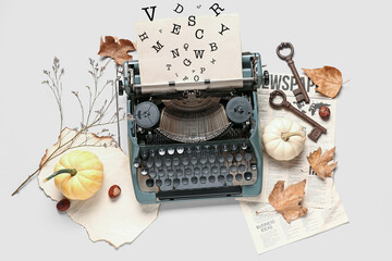 Vintage typewriter, autumn leaves, pumpkins and keys on white background