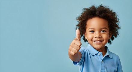Adorable African American Boy Giving a Thumbs Up on Blue Background, Smiling Brightly