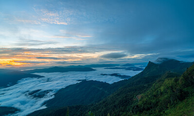 Sunrise over misty mountain valley with colorful sky and morning fog, beautiful landscape in northern Thailand.