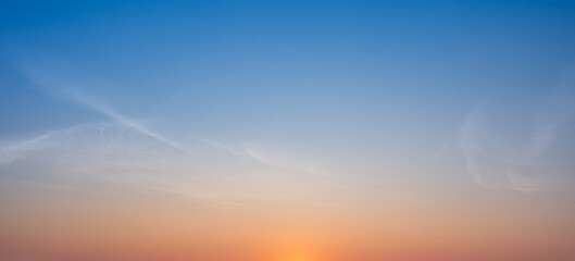 Bright early morning sky with soft pastel colors blending smoothly above the horizon.