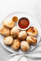 Overhead view of a plate of masa and pepper sauce, top view of food from northern nigeria masa rice cake and stew, nigerian ethnic foods